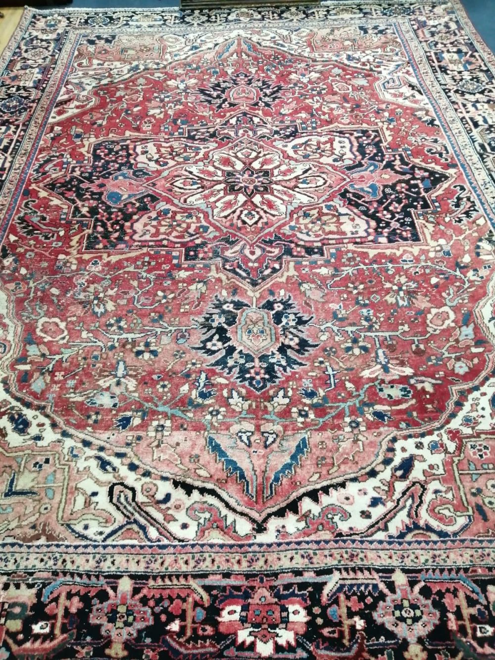 An Heriz red ground carpet, 370 x 280cm